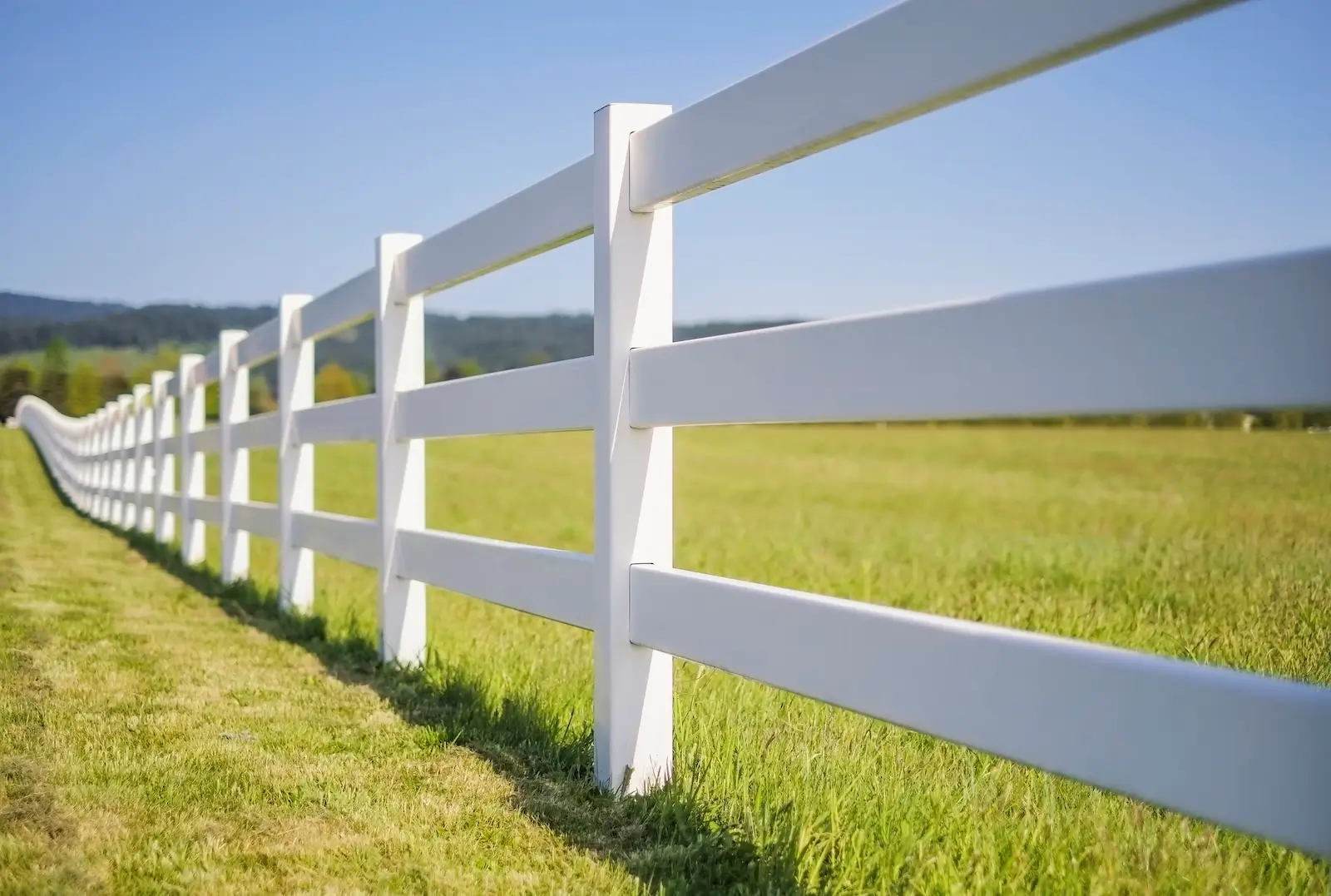 a long white plastic farm fence in the countryside